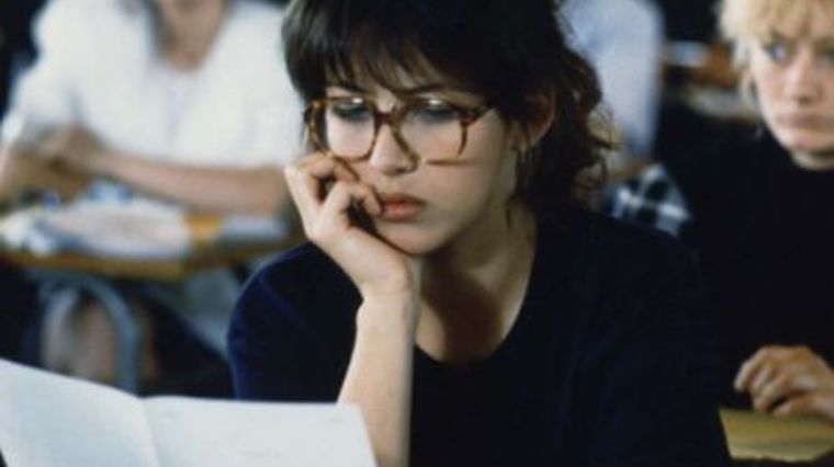 Sophie marceau dans le film L'étudiante qui étudie un ouvrage