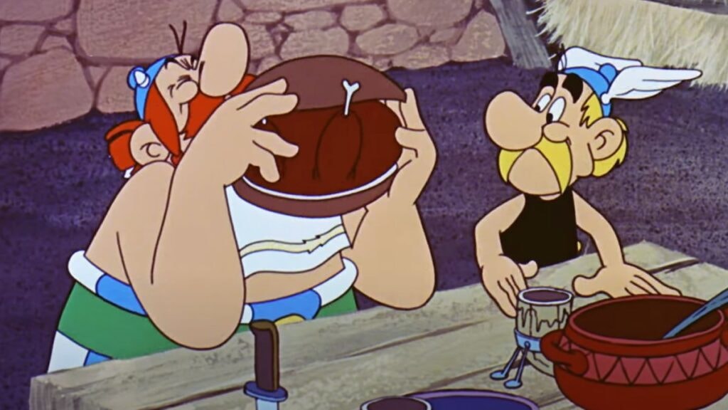 obélix qui mange un sanglier et astérix qui le regarde au début d'astérix et cléopâtre