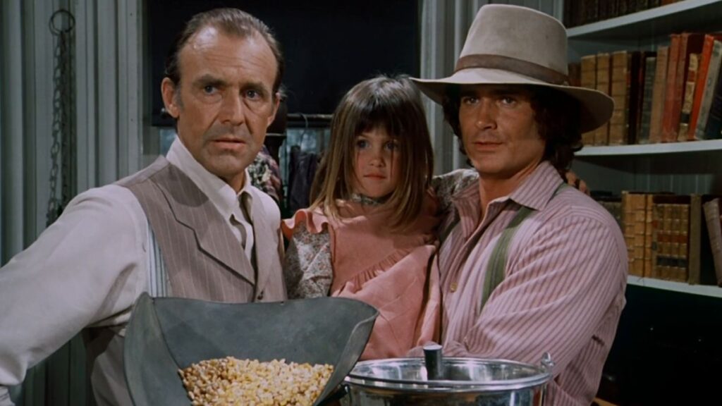 Nels Oleson, Carrie et Charles Ingalls dans La Petite Maison dans la Prairie.