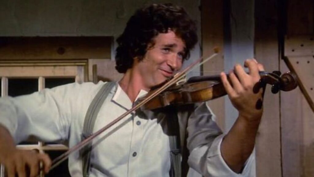 Charles Ingalls jouant du violon dans La Petite Maison dans la Prairie